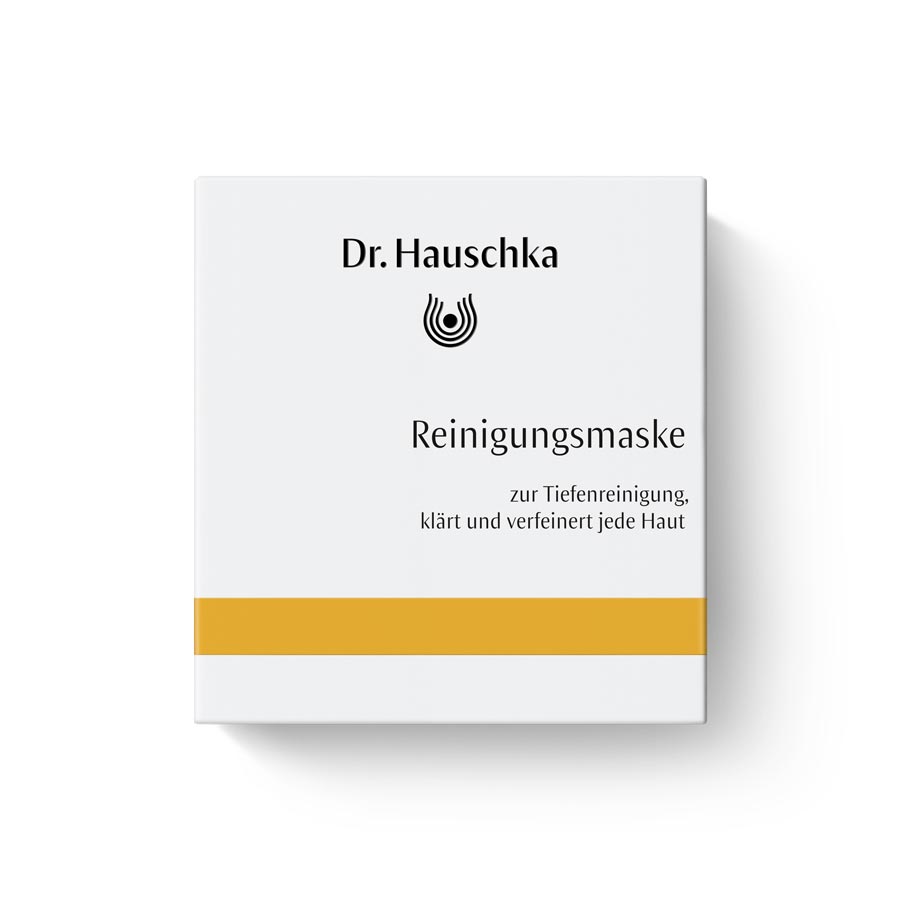 Puhdistusnaamio Dr. Hauschka Natural Skincare, valkoinen rasia oranssilla raidalla