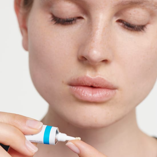 Lippenbläschen Akut Lippenpflege von Dr. Hauschka Naturkosmetik, Tube auf Finger aufgetragen