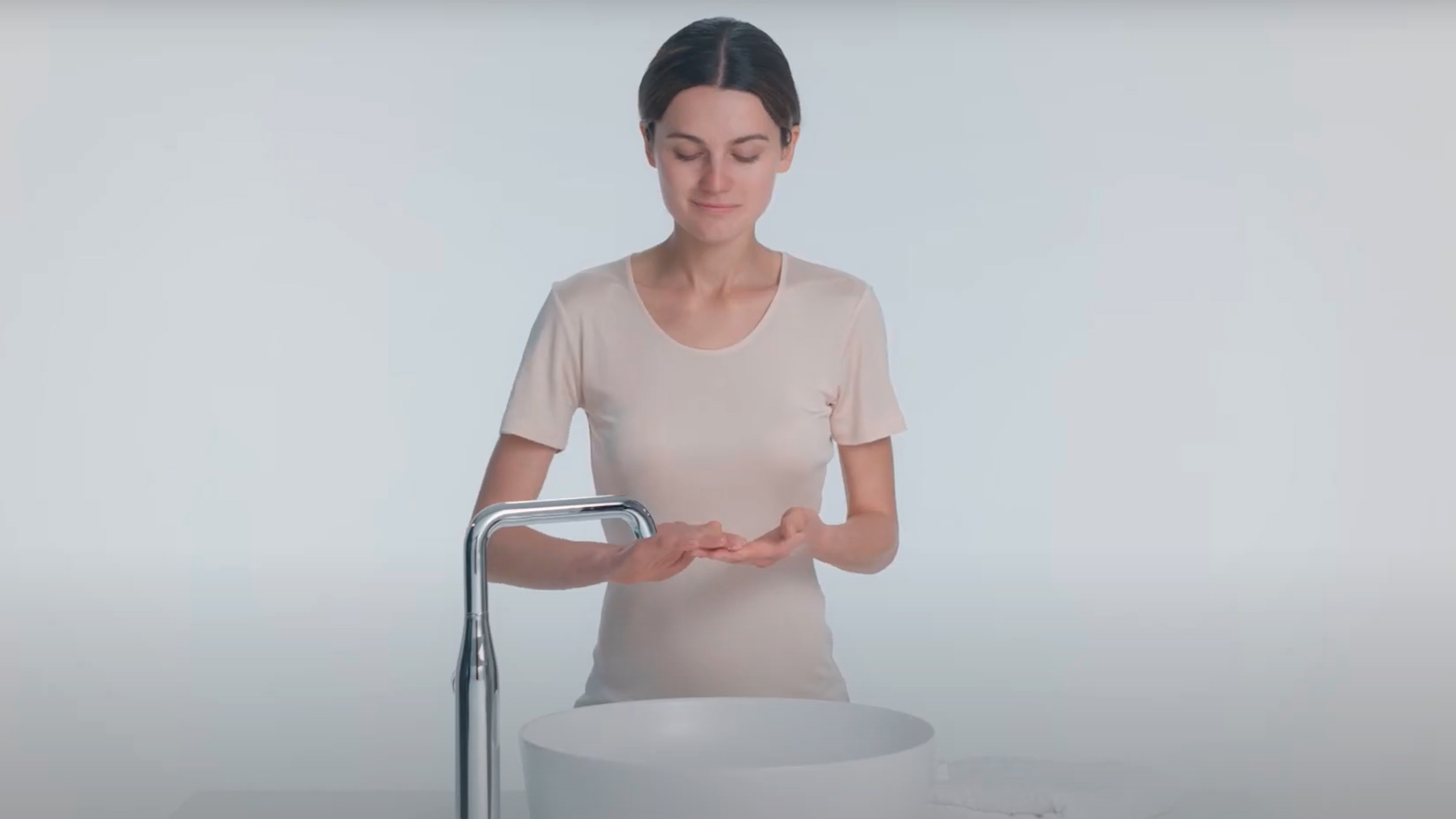Atmospheric image of a person at a washbasin